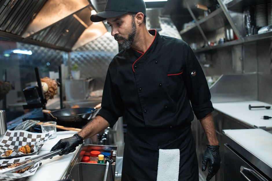 Professional catering chef preparing a gourmet meal