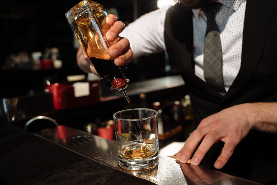 Bartender pouring a craft cocktail at an event